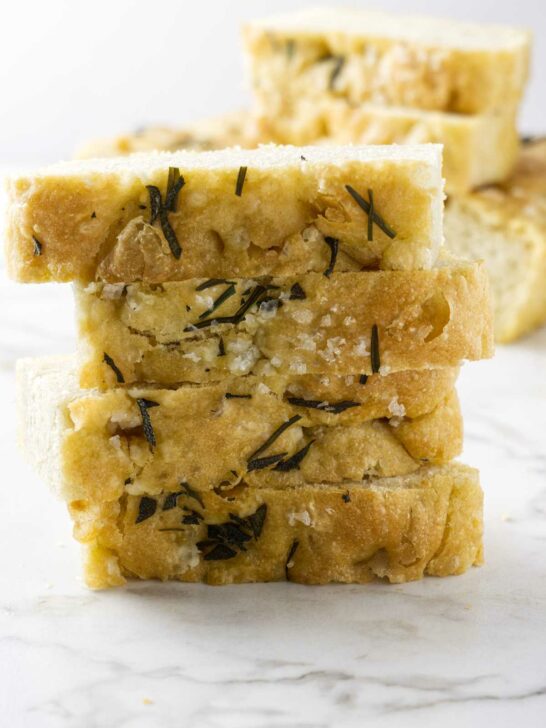 Einkorn rosemary focaccia bread slices stacked on each other.