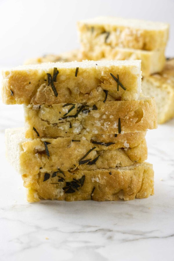 Einkorn rosemary focaccia bread slices stacked on each other.