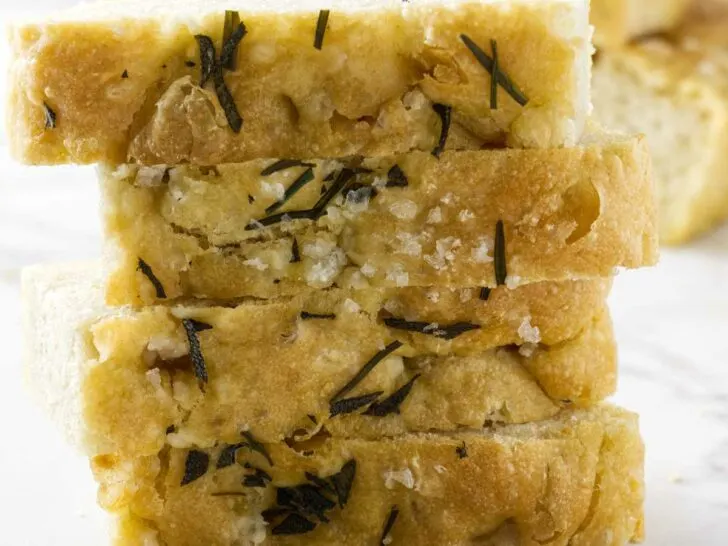 Einkorn rosemary focaccia bread slices stacked on each other.