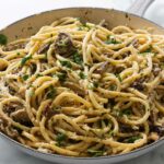 A skillet filled with wild mushroom pasta.