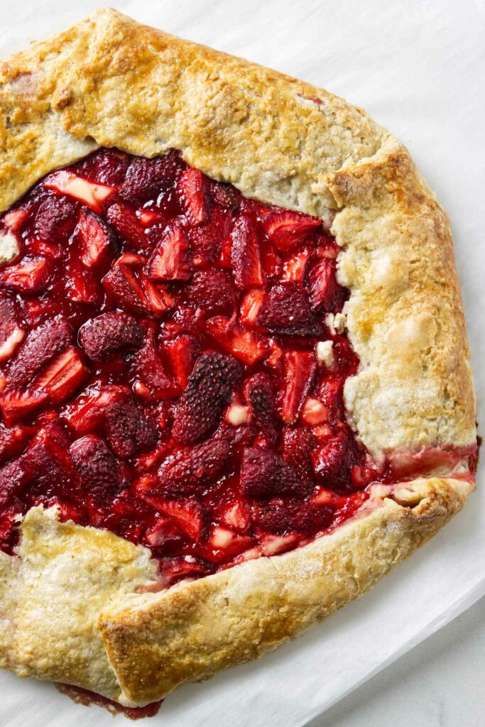 A cream cheese and strawberry galette with sugar on the crust.