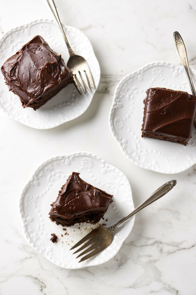 Three plates with servings of chocolate einkorn cake.