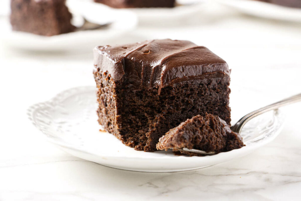 A fork with a bite of chocolate einkorn cake.