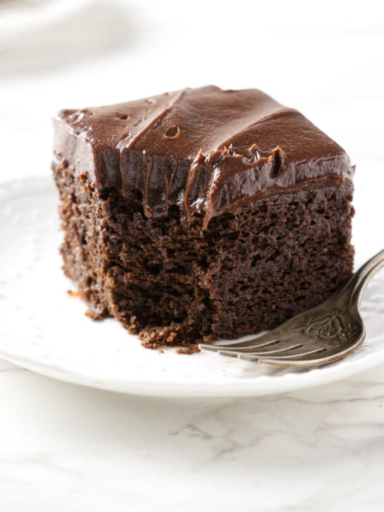 A partially eaten slice of einkorn chocolate cake.