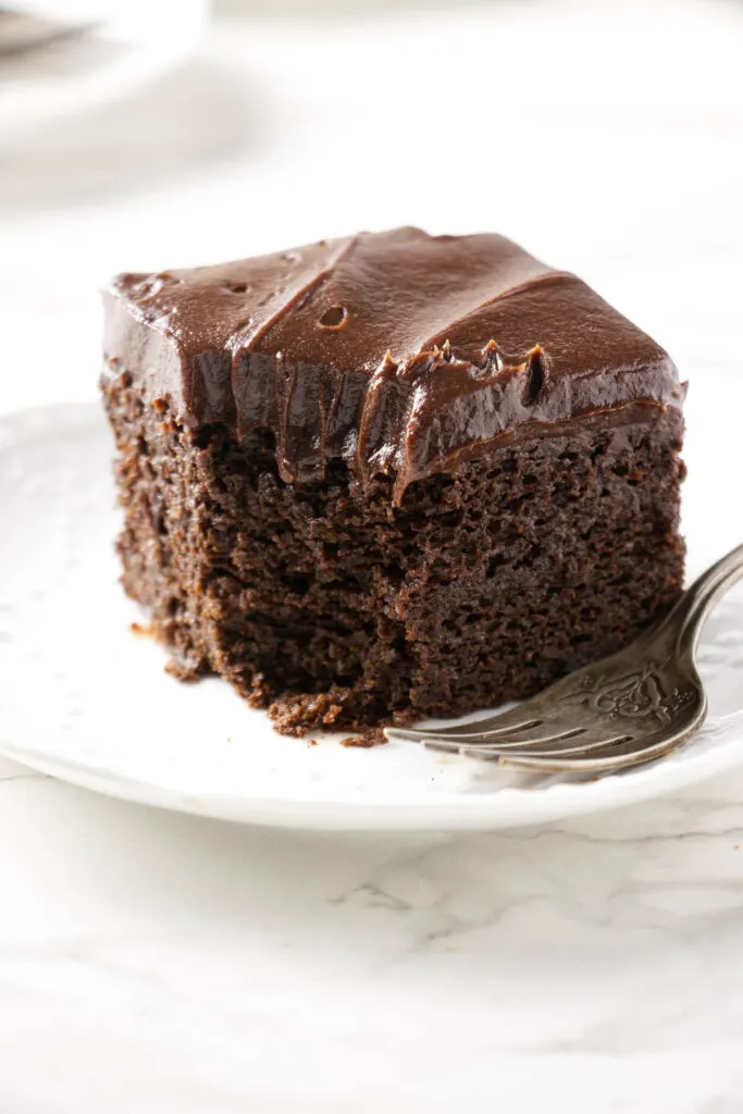 A partially eaten slice of einkorn chocolate cake.