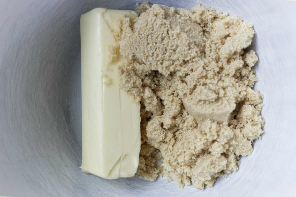 Butter and sugar in a mixing bowl.