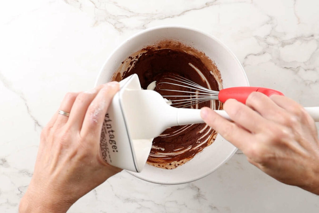 Adding sour cream to einkorn cake batter.