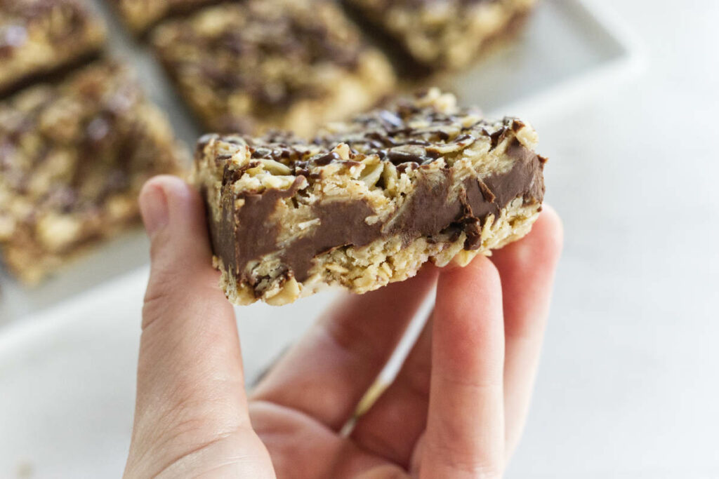 A hand holding a no bake nutella oatmeal bar.