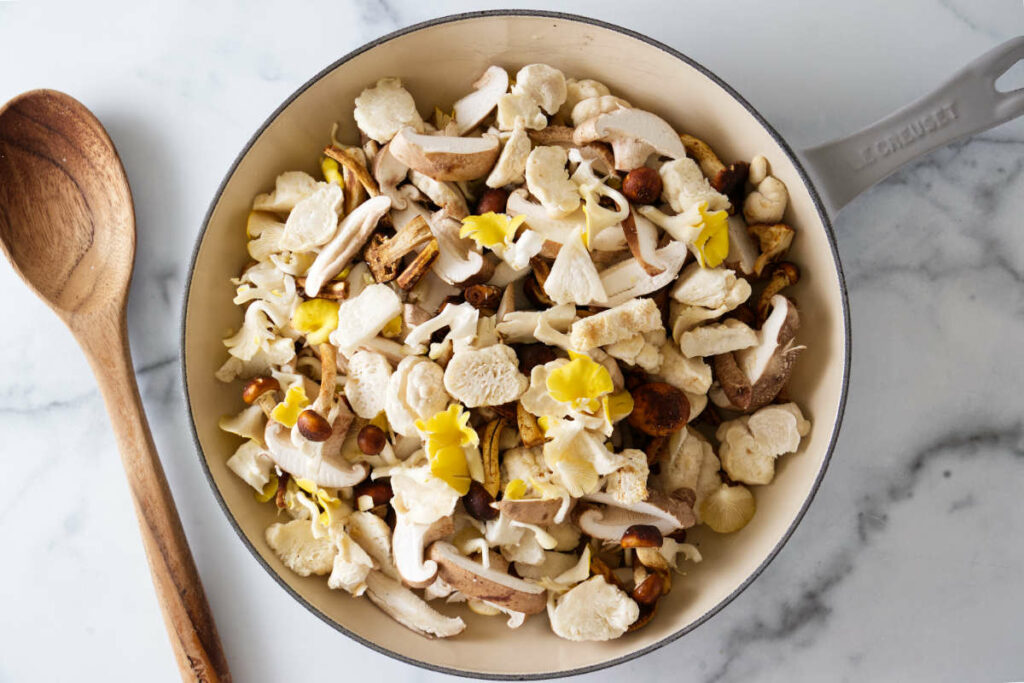 Wild mushrooms ready to cook in a skillet.