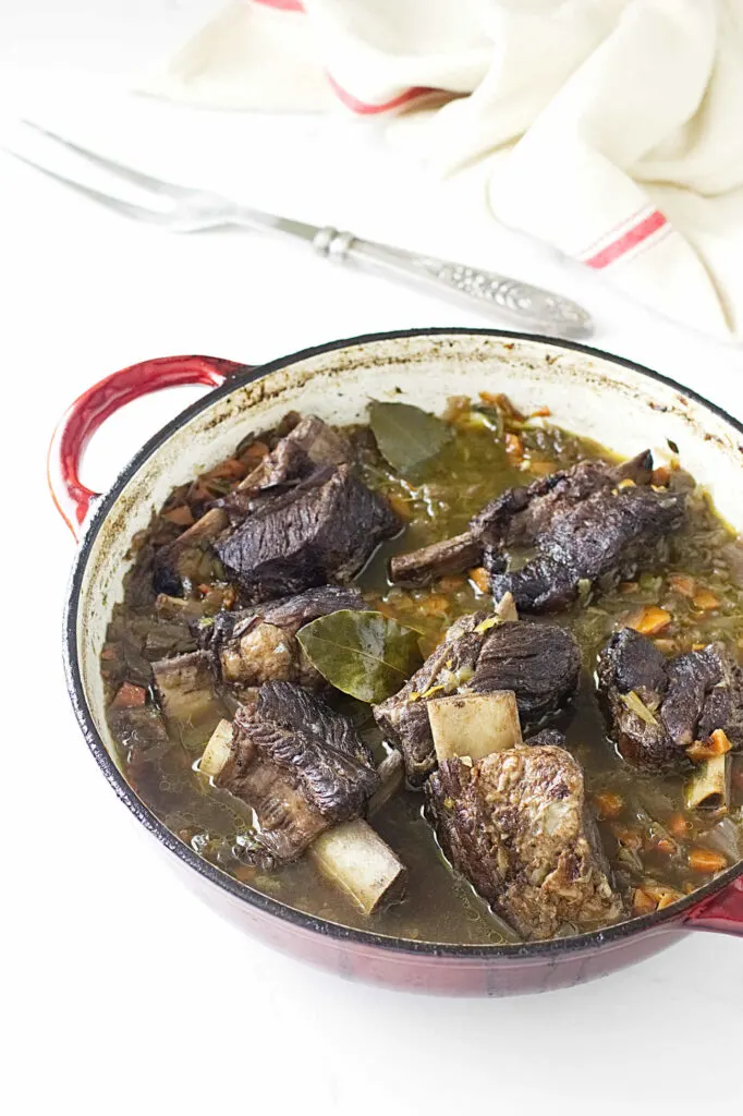 A Dutch oven filled with beer braised beef short ribs.