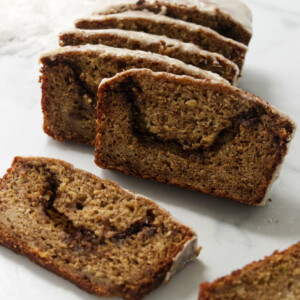 Slices of cinnamon swirl apple bread with maple icing.