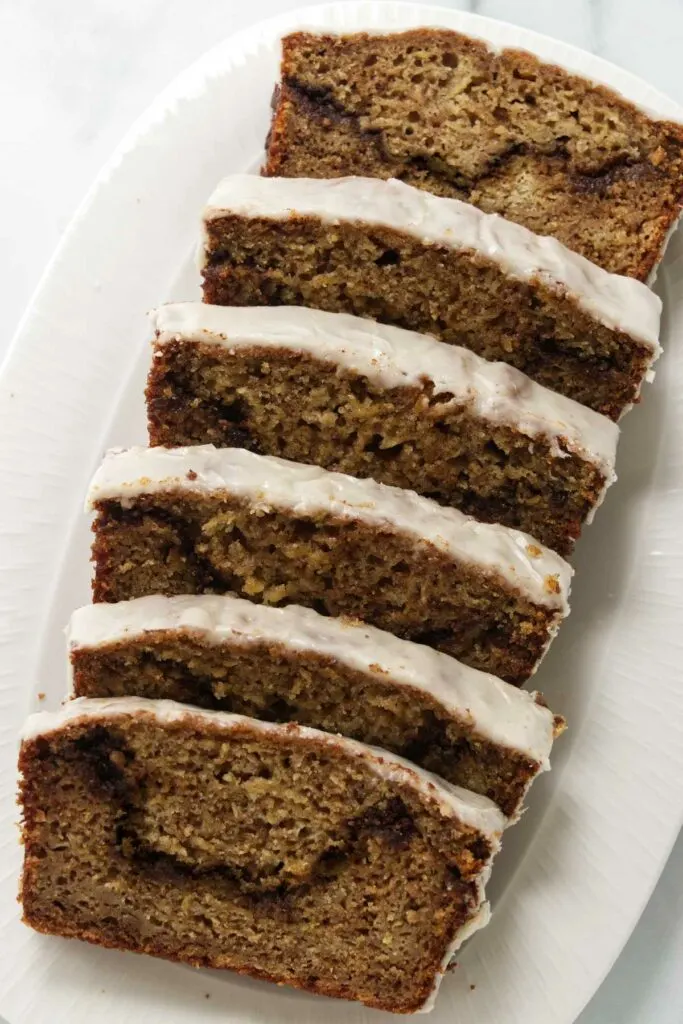 Slices of cinnamon swirl apple quick bread on a plate.