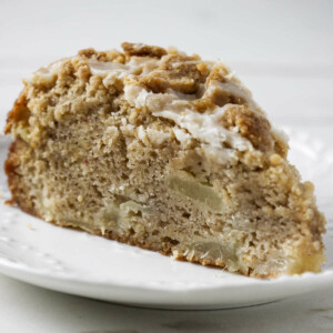 A pear crumb cake with a streusel topping on a plate.