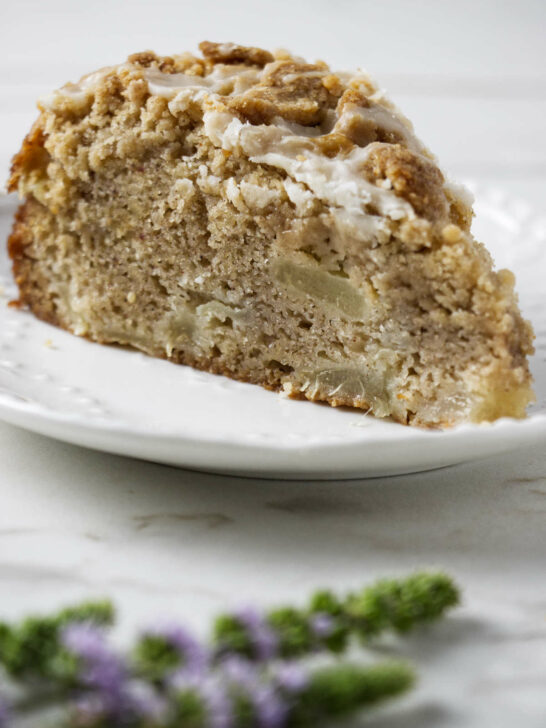 A slice of pear crumble cake with a streusel topping.