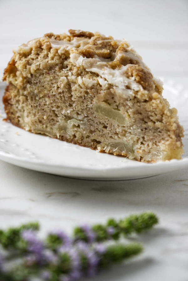 A slice of pear crumble cake with a streusel topping.