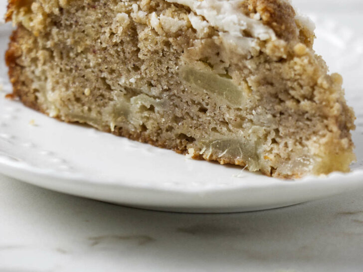 A slice of pear crumble cake with a streusel topping.