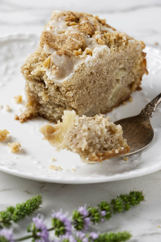 A sour cream pear coffee cake on a plate.