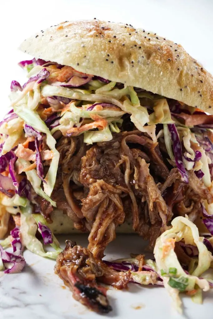 A sandwich made with bbq pulled pork in crock pot.