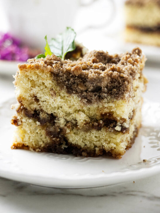 A slice of sourdough discard coffee cake with a cinnamon swirl.