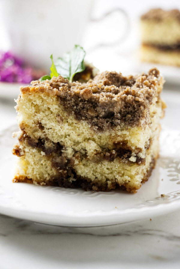 A slice of sourdough discard coffee cake with a cinnamon swirl.