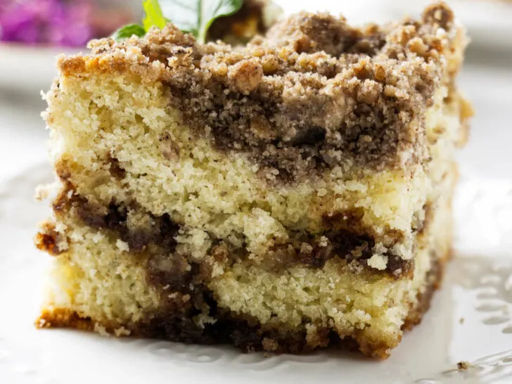 A slice of sourdough discard coffee cake with a cinnamon swirl.