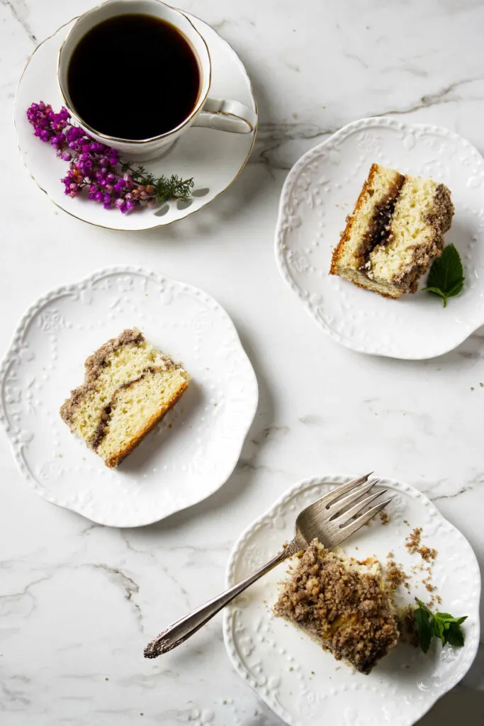 Three slices of sourdough crumb cake with a cup of coffee.