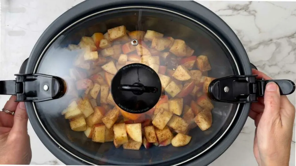 Adding a lid on the crockpot to reduce cook the apples down to make apple butter.