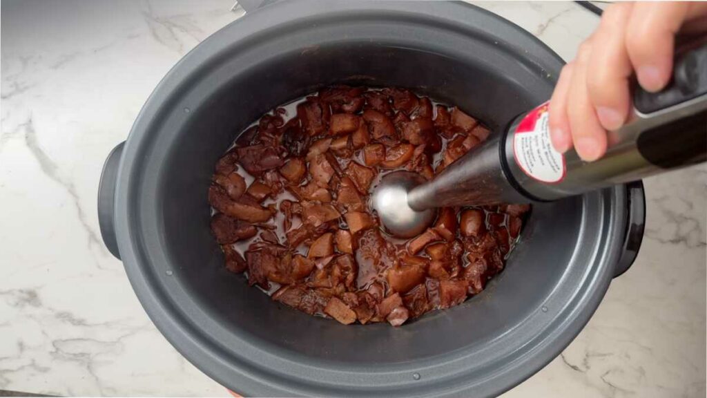 Blending apple butter in a crockpot.