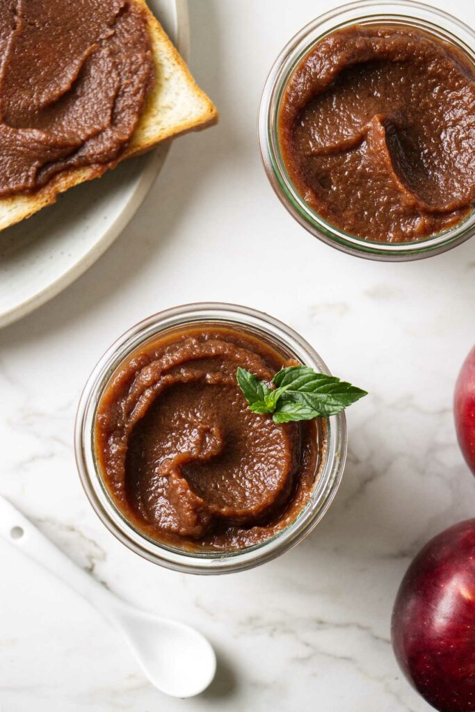 Two jars of crockpot apple butter made with no sugar.