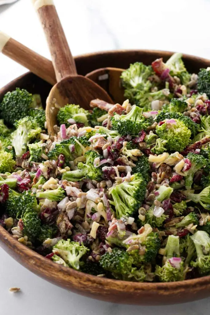 Salad in a bowl with utensils ready to serve.