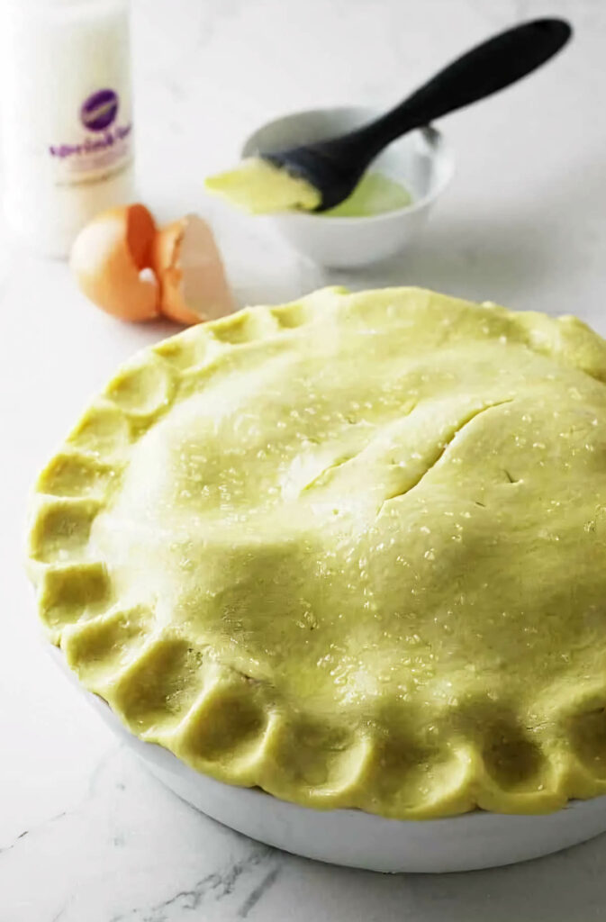 A top layer of pie dough with einkorn flour on a fruit pie.