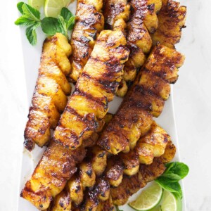 A serving platter with slices of cinnamon grilled pineapple.