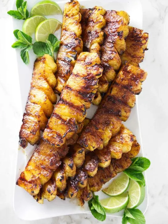 A serving platter with slices of cinnamon grilled pineapple.