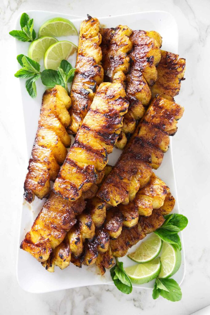 A serving platter with slices of cinnamon grilled pineapple.