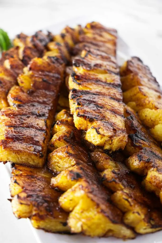 Several slices of grilled pineapple with cinnamon sugar.