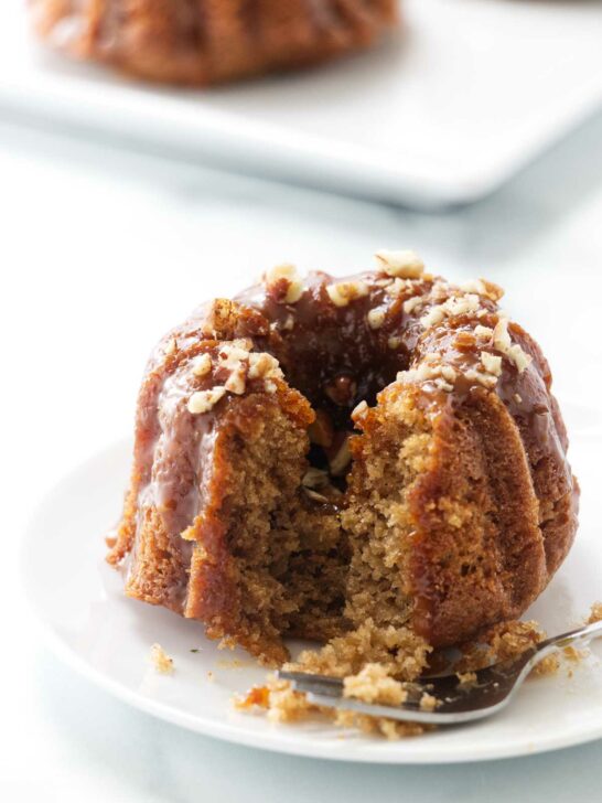 A fork next to a mini apple bund cake.