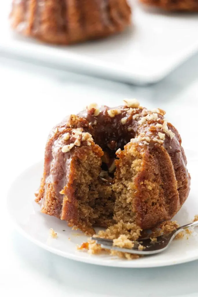 A fork next to a mini apple bund cake.