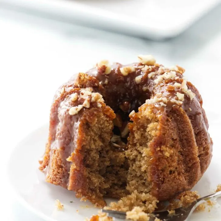 A fork next to a mini apple bund cake.