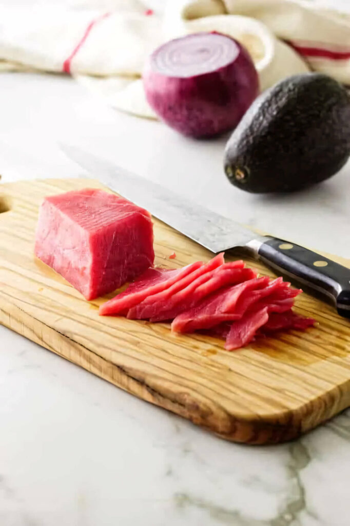 Slicing fresh ahi tuna for sashimi.