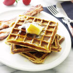 Pouring syrup on waffles with kamut flour.