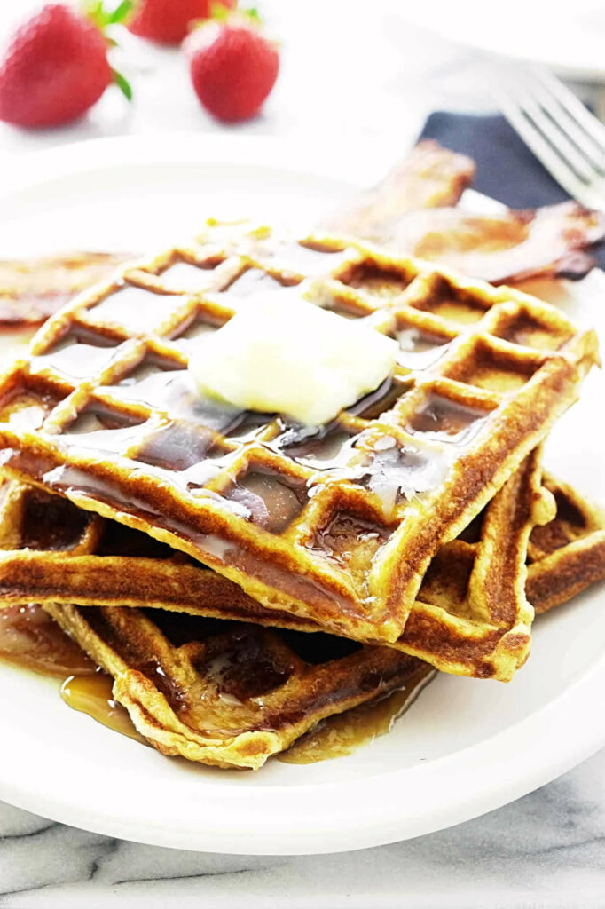 A pat of butter melting on a buttermilk kamut waffle.