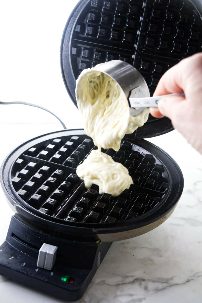 Waffle batter made with kamut flour being poured on a waffle iron.