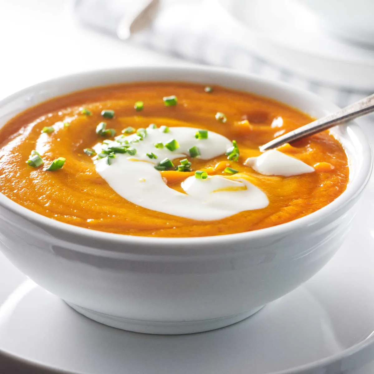 A serving of carrot onion soup in a bowl