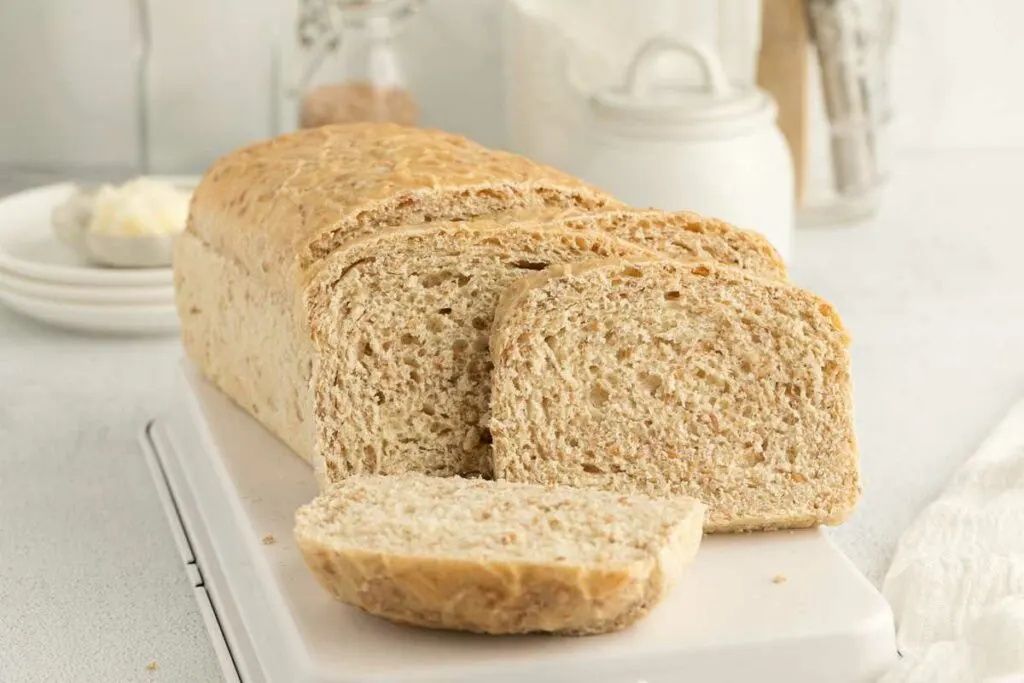 A sliced loaf of bread made with whole wheat and bulgur or cracked wheat.