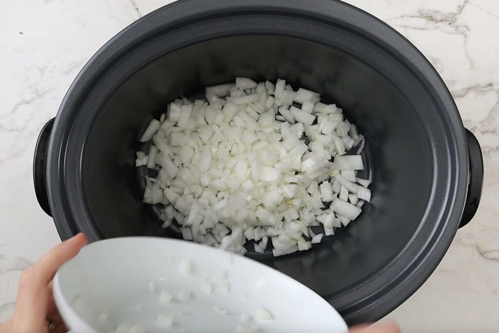 Diced onions in a slow cooker.