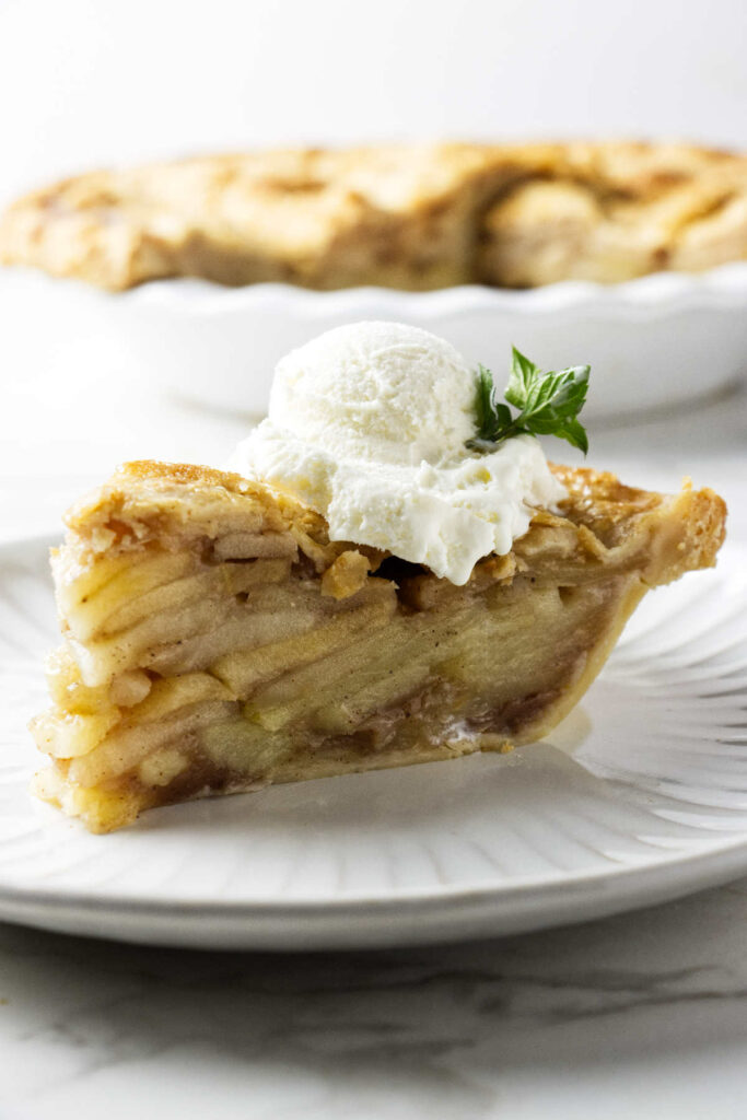 Spiced apple pie with a scoop of ice cream on top.