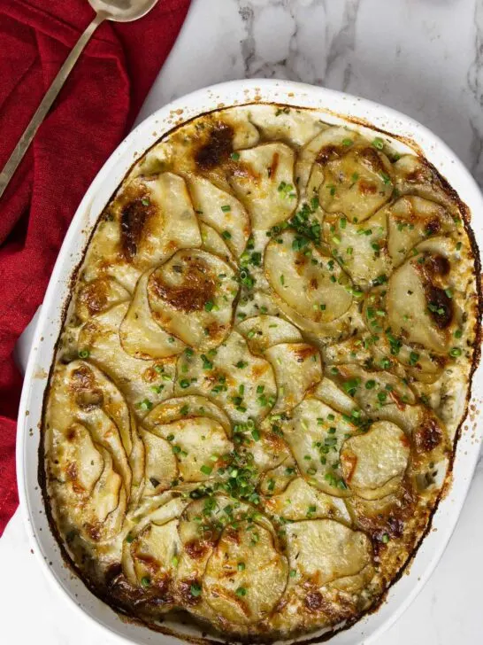 A baking dish with rosemary parmesan potatoes gratin.