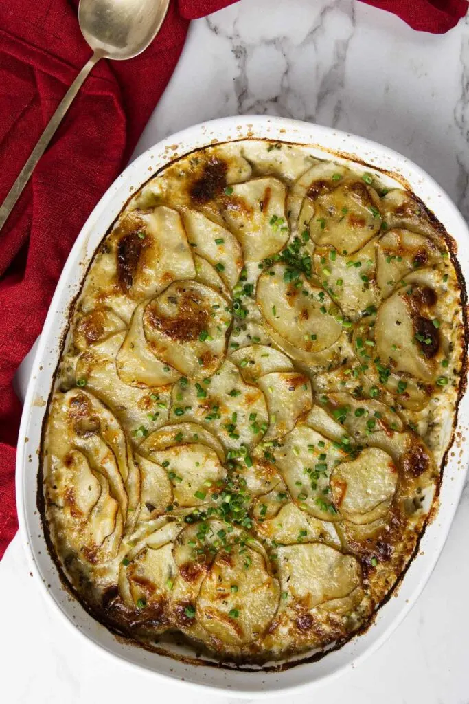 A baking dish with rosemary parmesan potatoes gratin.