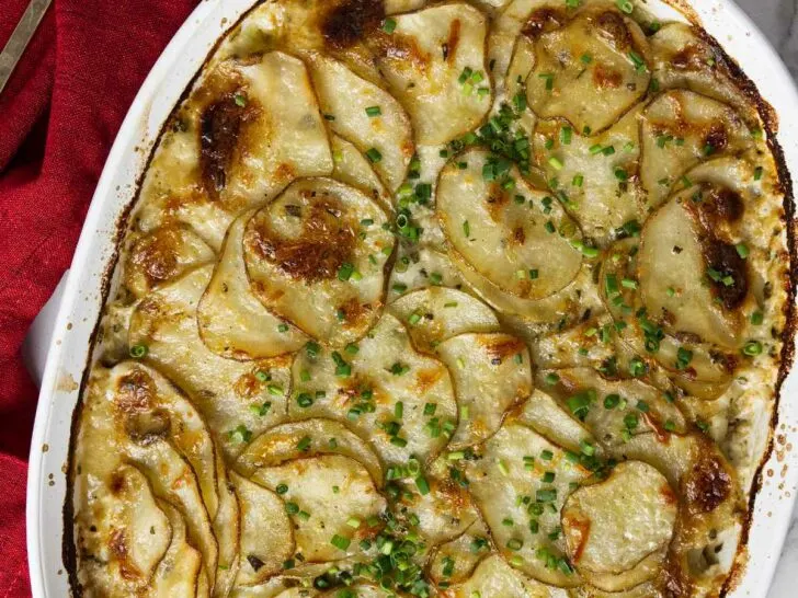 A baking dish with rosemary parmesan potatoes gratin.