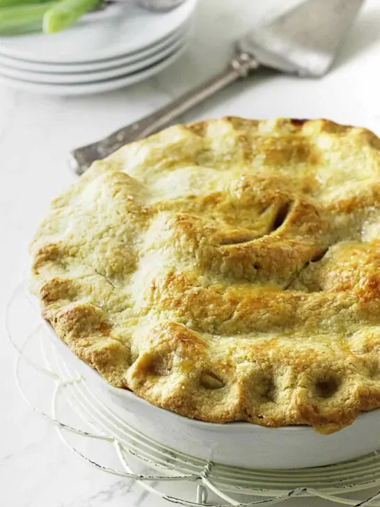 Golden brown einkorn pie crust on top of a fruit pie.